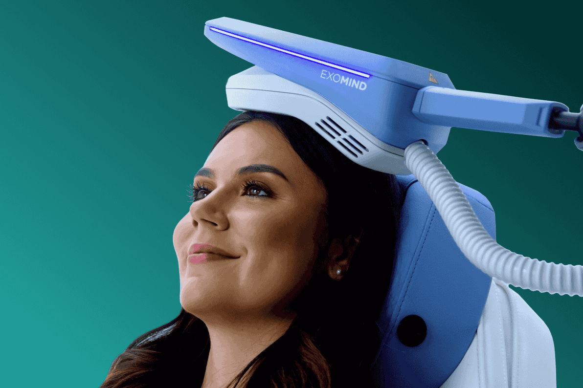 A woman leans back and smiles as she receives a mental health treatment in Elgin, IL.
